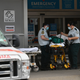 Healthcare workers prepare a gurney outside Maimonides Medical Center in the Brooklyn borough of New York on April 23.